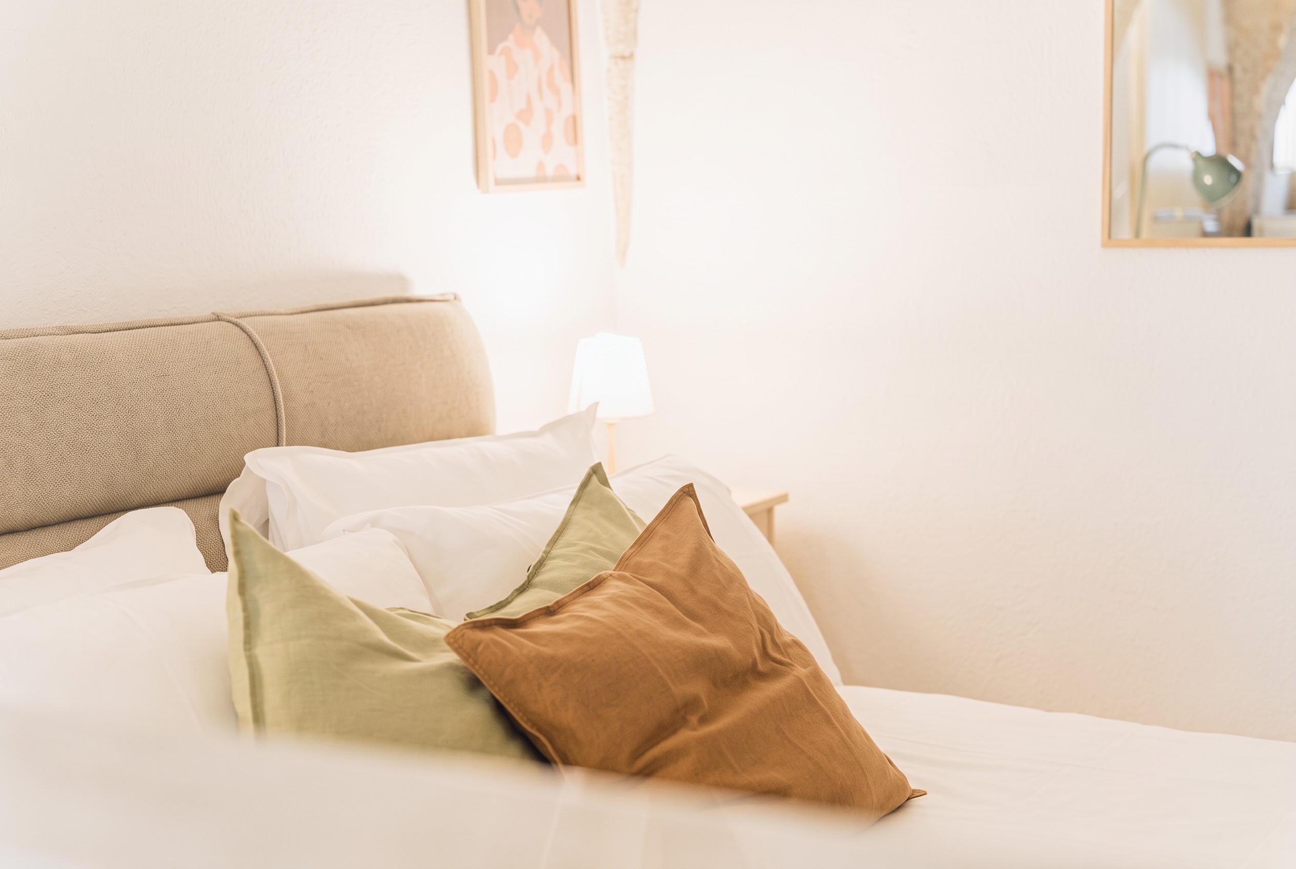 Natural linen cushions on the prepared bed