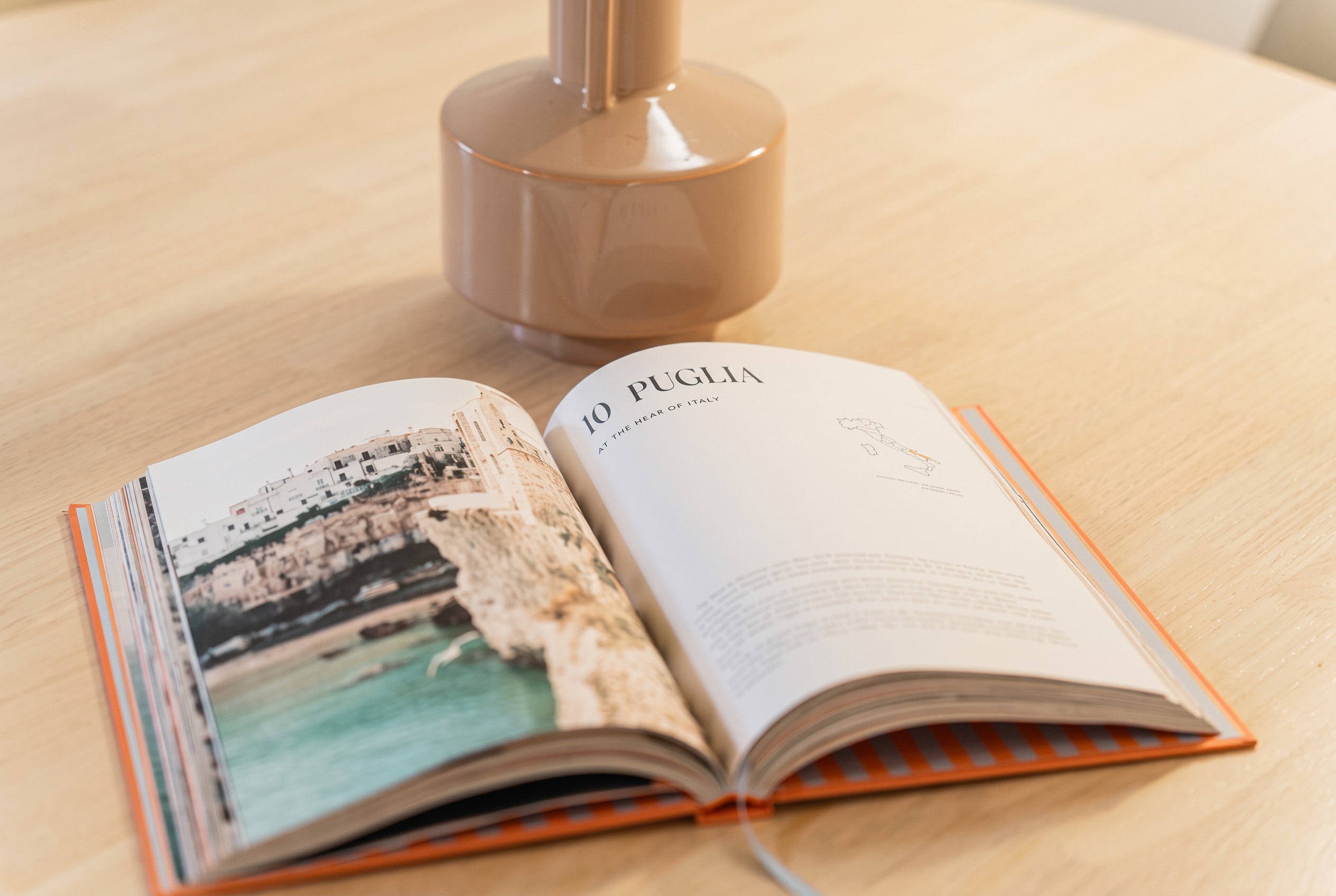 Open guidebook celebrating Puglia